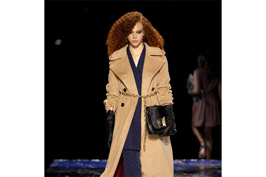 Curly red-haired model posing in parade