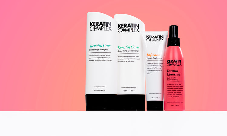 The image showcases four Keratin Complex hair products displayed on a clean, white surface against a gradient orange background.