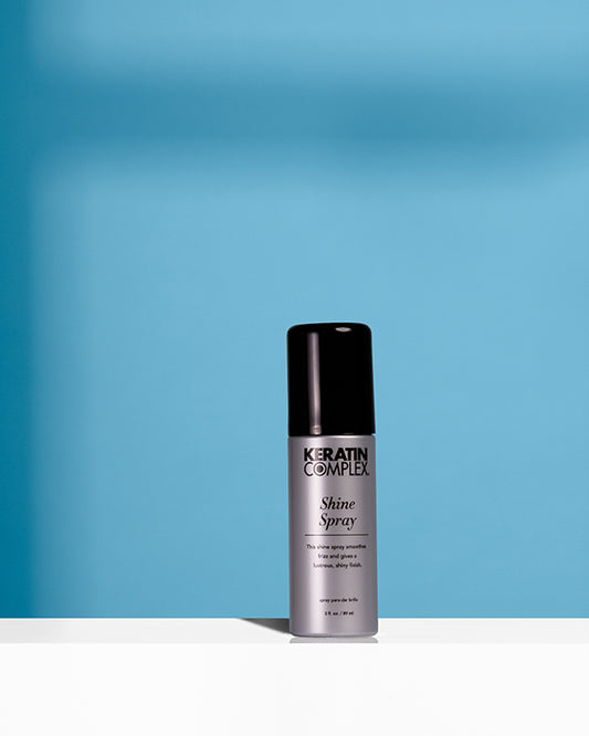 Shine spray bottle on blue background