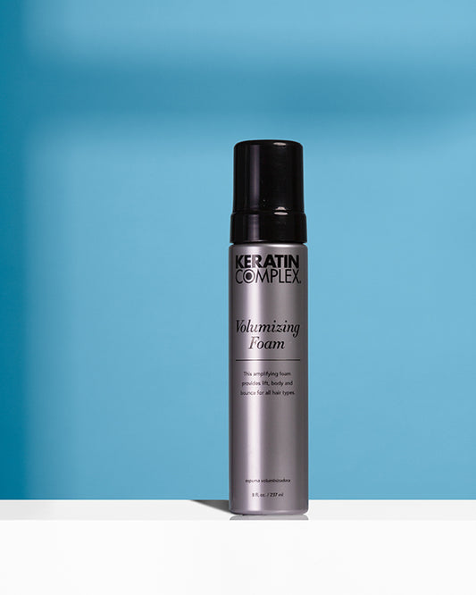 Volumizing Foam bottle on blue background