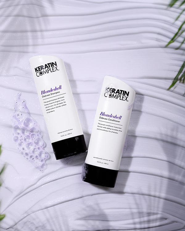 Blondeshell® Debrass Shampoo and conditioner bottle on white textured background