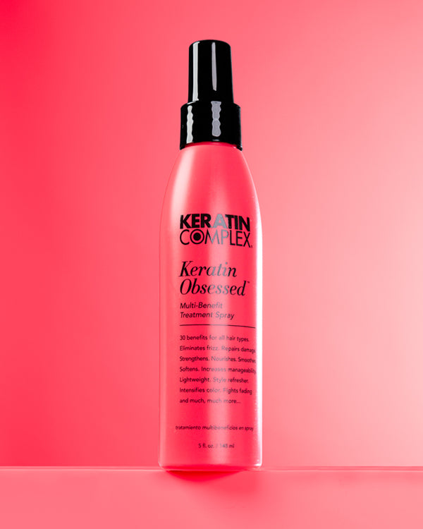Keratin Obsesed bottle on a pink background