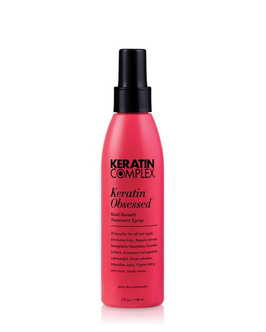 A pink bottle of Keratin Complex Keratin Obsessed  Multi-Benefit Treatment Spray 5 oz. on a clear background.