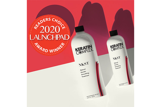 Image showing two white bottles of keratin complex and a badge of a Launchpad Award Winner 
