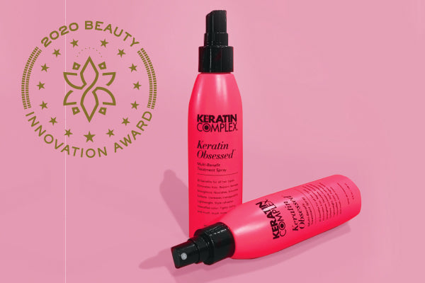 A closeup of two Keratin Complex products, the background is pink