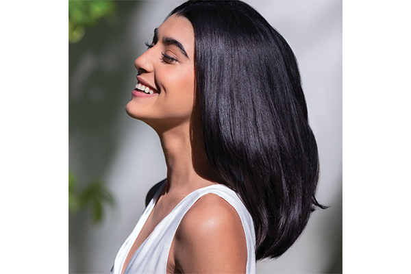 Woman in profile smiling with short black hair