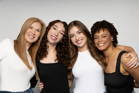 Four models in the photo. First model has blonde hair, the second mode has curly dark brown hair, the third model has light brown hair and the fourth model has dark curly hair  