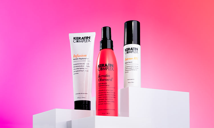 Keratin Complex hair care products displayed on white podiums against a pink background, featuring Infusion, Keratin Obsessed and Intense RX