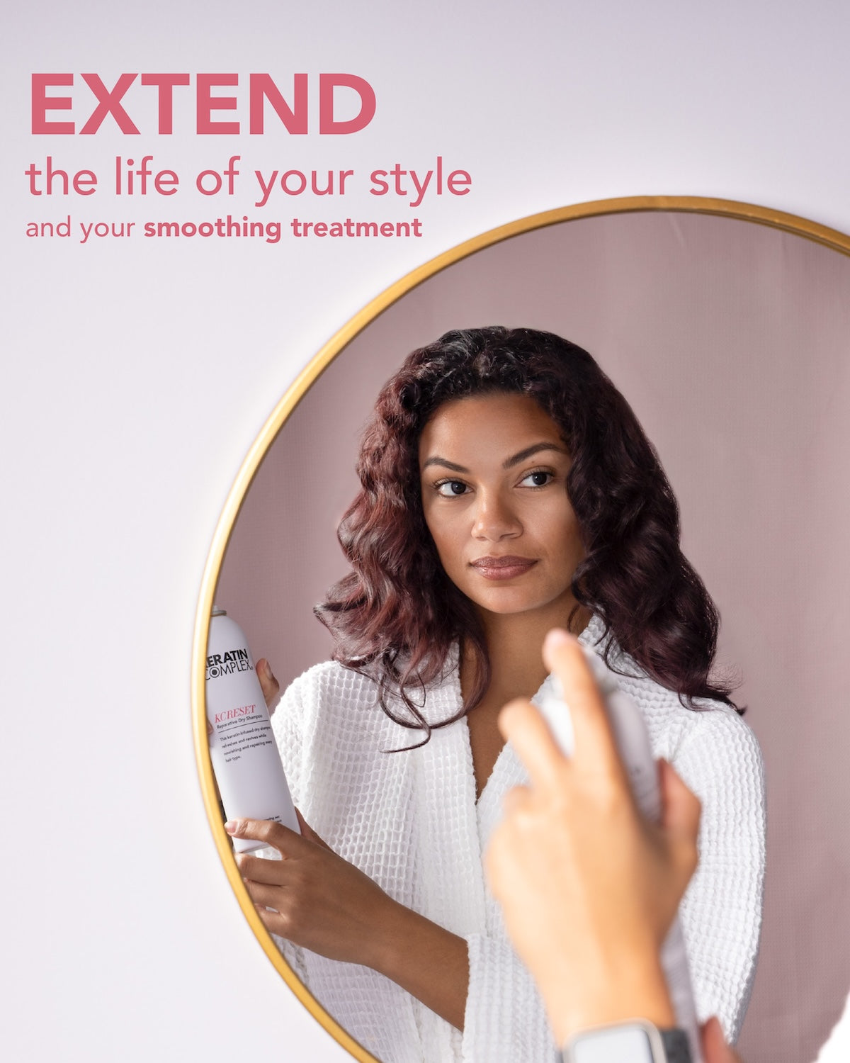 A woman in a white textured robe stands in front of a round mirror.||EXTEND the life of your style and your smoothing treatment.