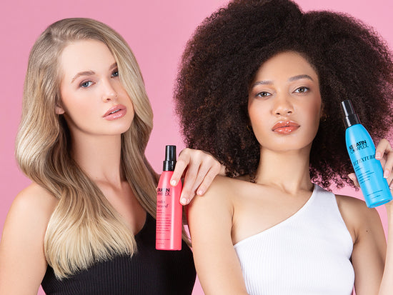 Two models with different hair types, one with straight blonde hair and the other with natural curly hair, holding Keratin Complex styling products against a pink background.