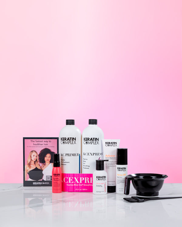 A complete set of Keratin Complex small EXPRESS Service Kit displayed on a pink surface