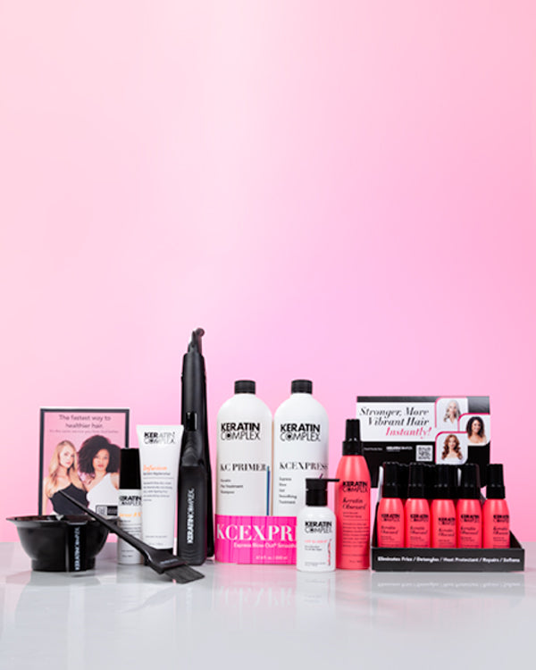 A complete set of Keratin Complex large EXPRESS Service Kit displayed on a pink gradient surface