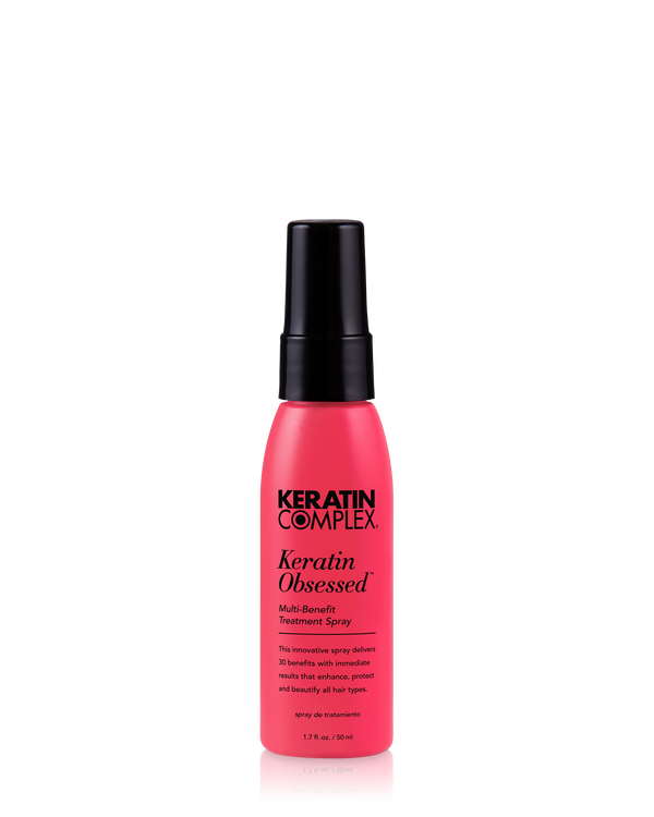 A pink bottle of Keratin Complex Keratin Obsessed Multi-Benefit Treatment Spray 1.7 oz. on a clear background.